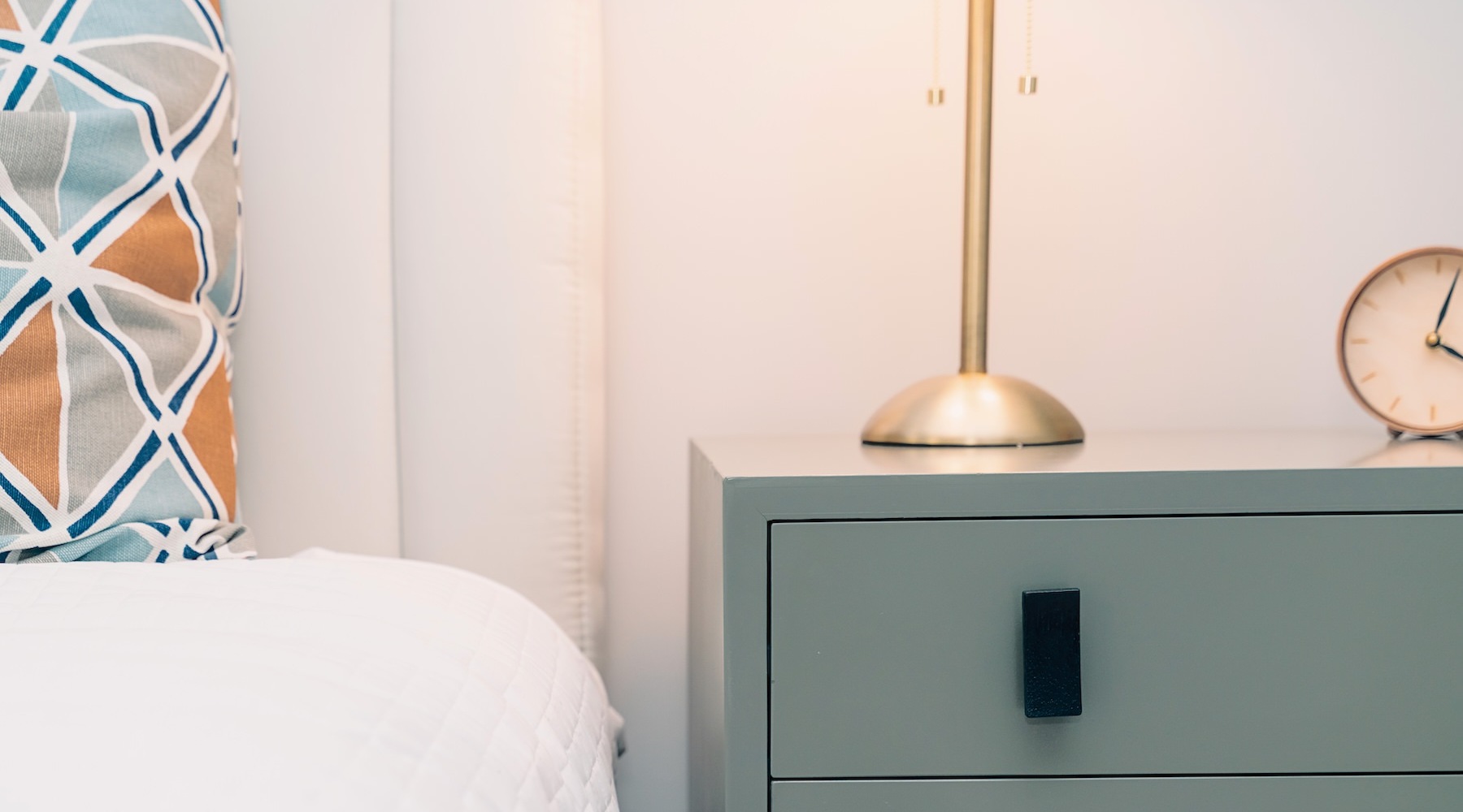 a bed next to a nightstand