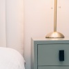 a bed next to a nightstand
