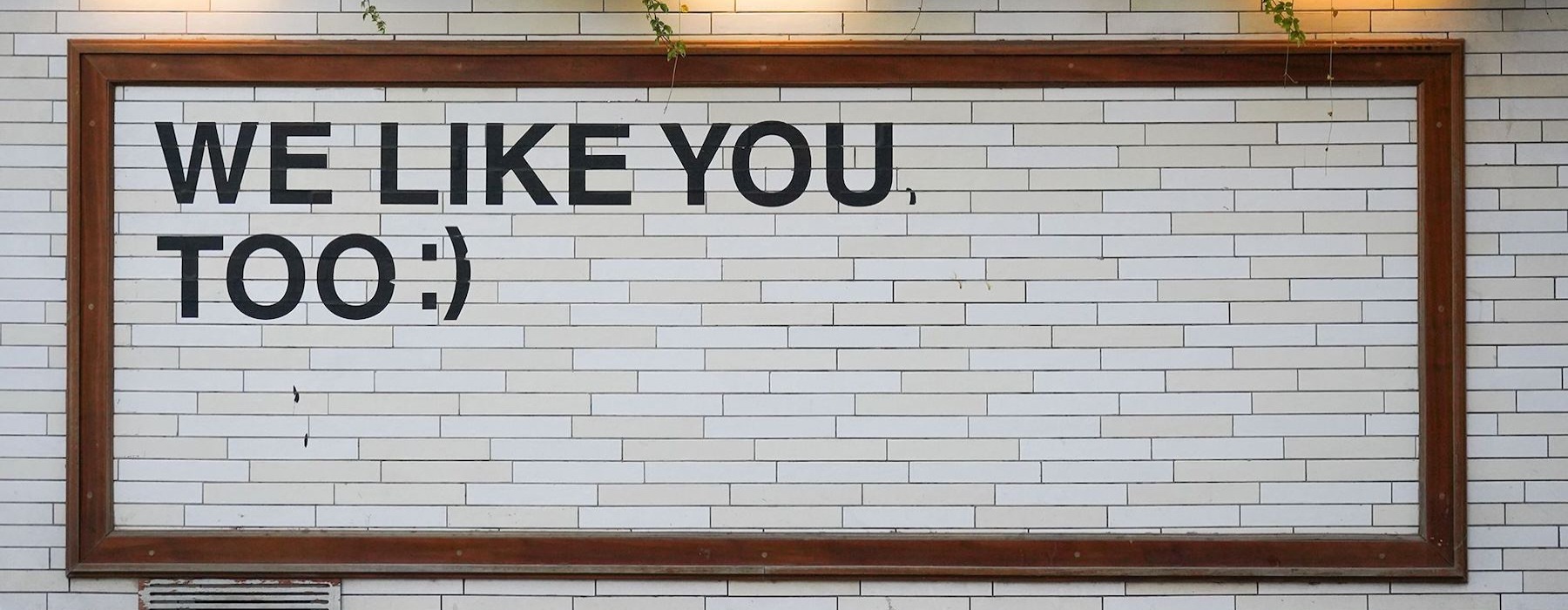 a sign on a tile wall that says